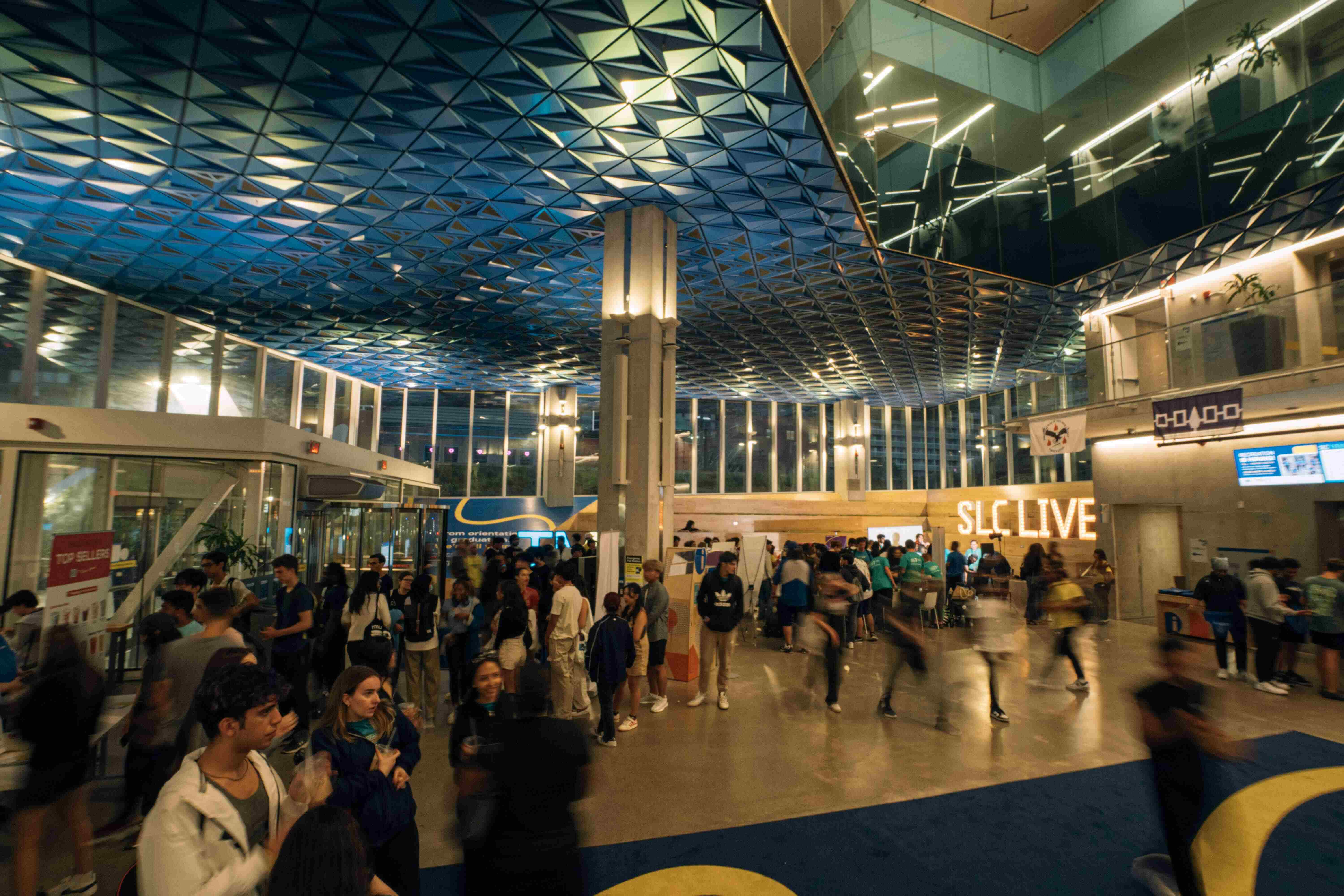 Wide shot of students walking in the SLC during SLC Live.